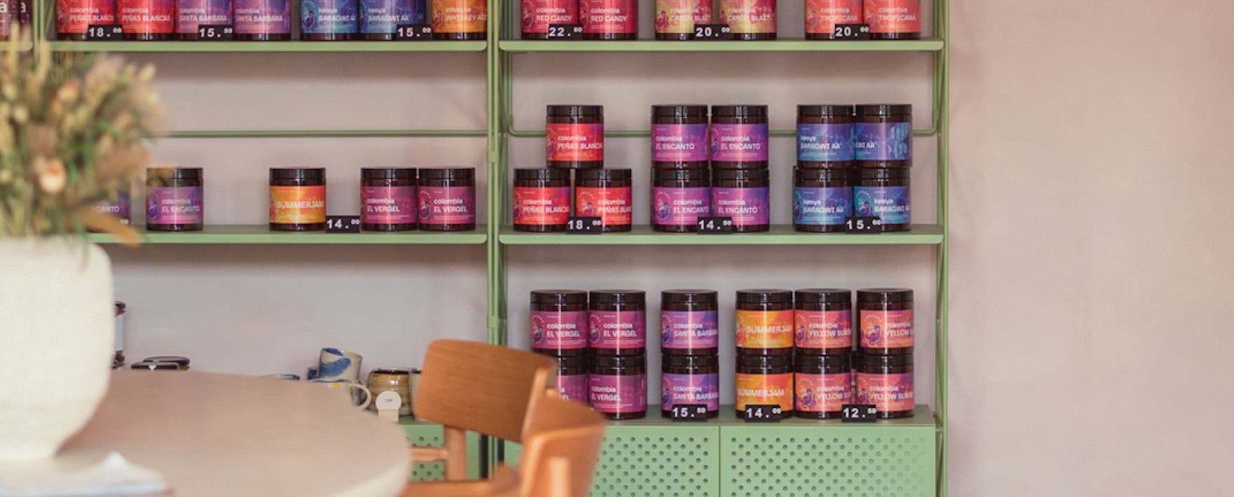 Mint green shelving stacked with Concept Coffee retail tins at the shop's Kosicka location