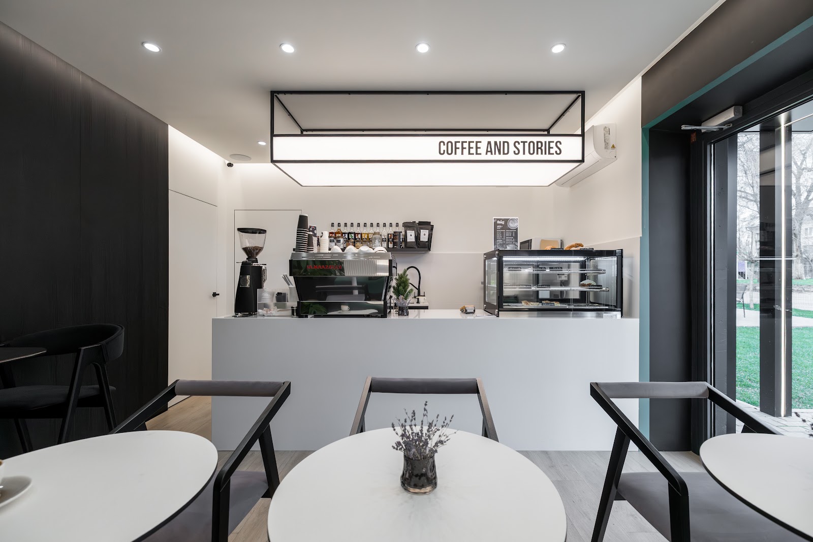The clean, bright espresso bar counter at Coffee Hug with a shelf of coffee bags behind it