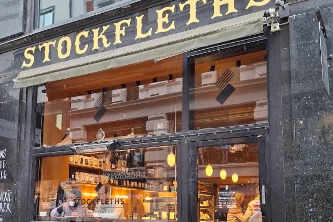 The gold-lettered STOCKFLETH'S fascia above the Lille Grensen storefront, retail shelves and pendant lights visible through the windows