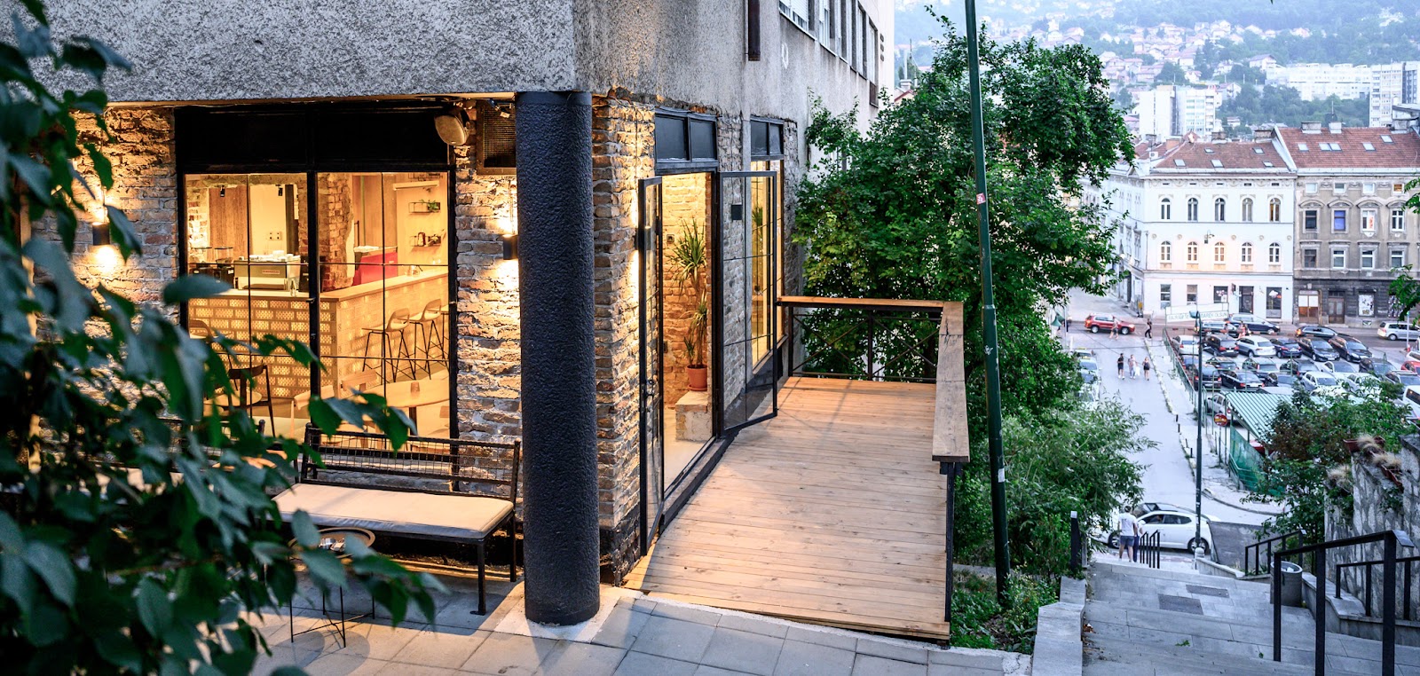 Kawa's glass fronted storefront and wooden terrace deck overlooking the hillside in Mejtas