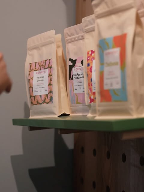 Retail bags of single origin coffee beans on a shelf at a Mimoza cafe in Tirana