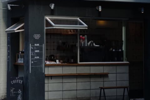 The small walk up window of About Life Coffee Brewers on a Dogenzaka street corner in Shibuya